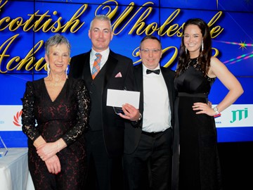 Lee Brown receives Supplier Sales Executive of the Year from Sugro's business development manager Peter Carrell, with Kate Salmon, left, executive director, Scottish Wholesale Association and host Jennifer Reoch of STV